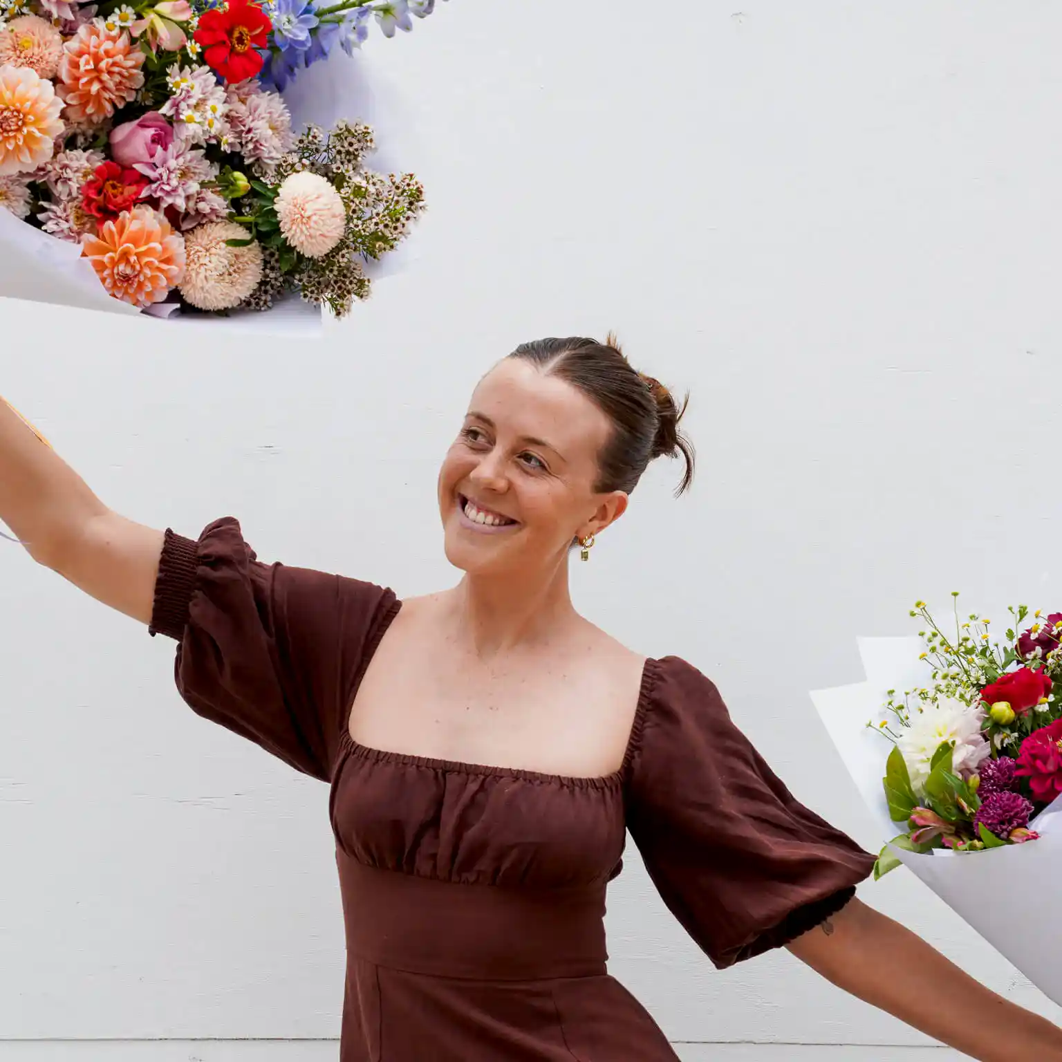A lady dancing with flowers at Poppy Rose Flower Delivery in Brisbane