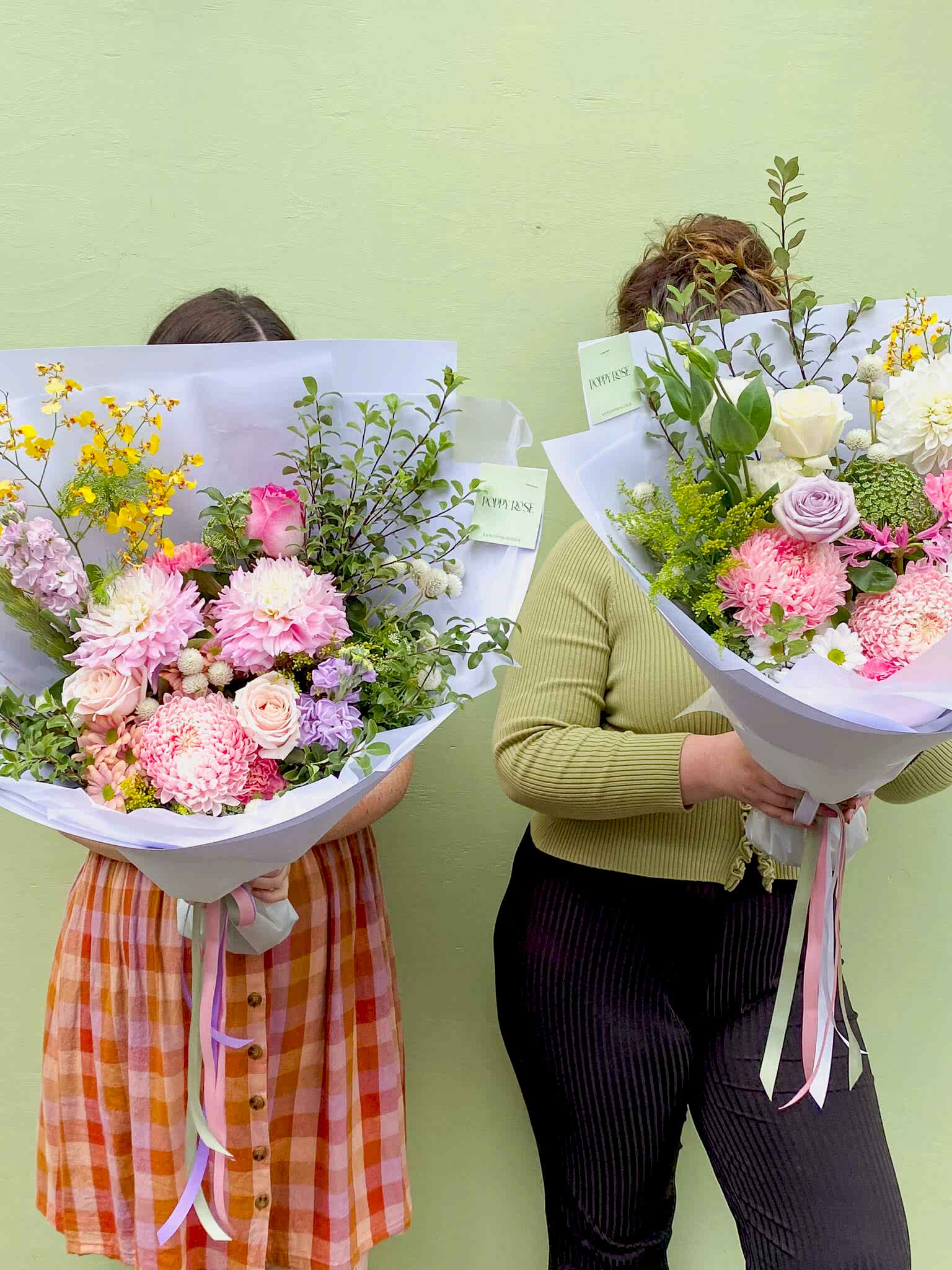 Two ladies holding big bunches of flowers from Poppy Rose in Brisbane