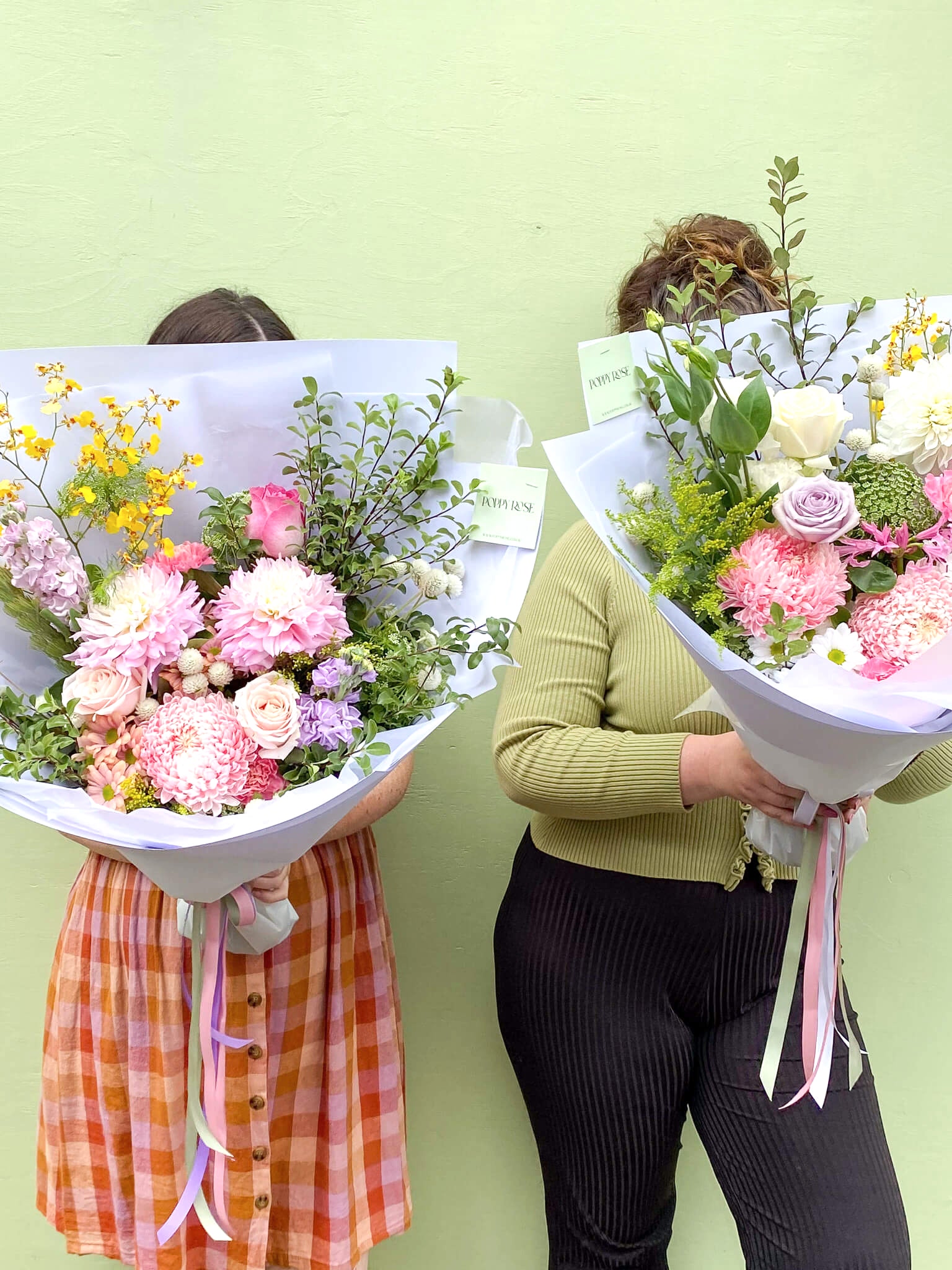 Two ladies holding big bunches of flowers from Poppy Rose in Brisbane