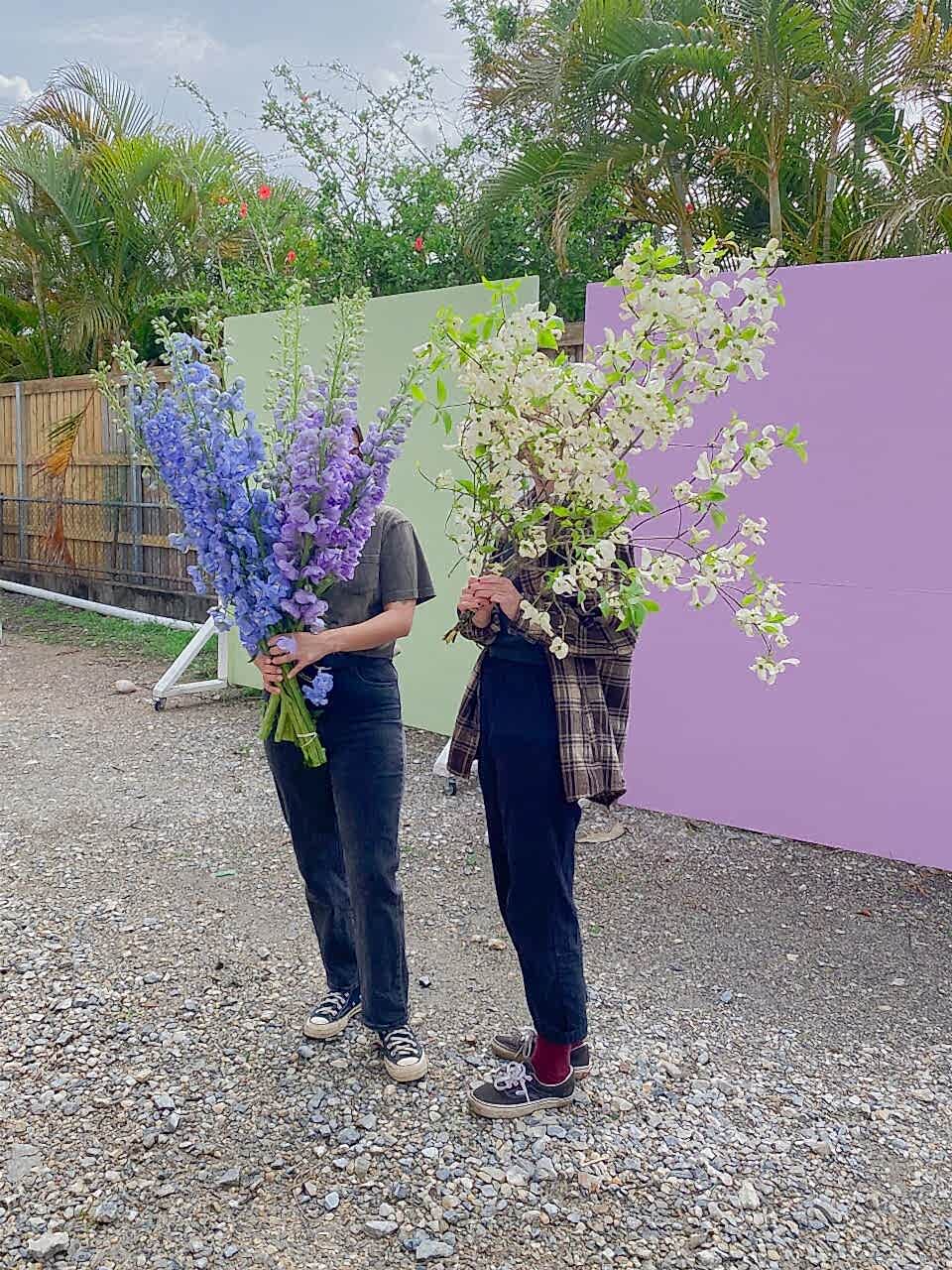 Girls holding big bunches of flowers for delivery in Brisbane by Poppy Rose Flowers