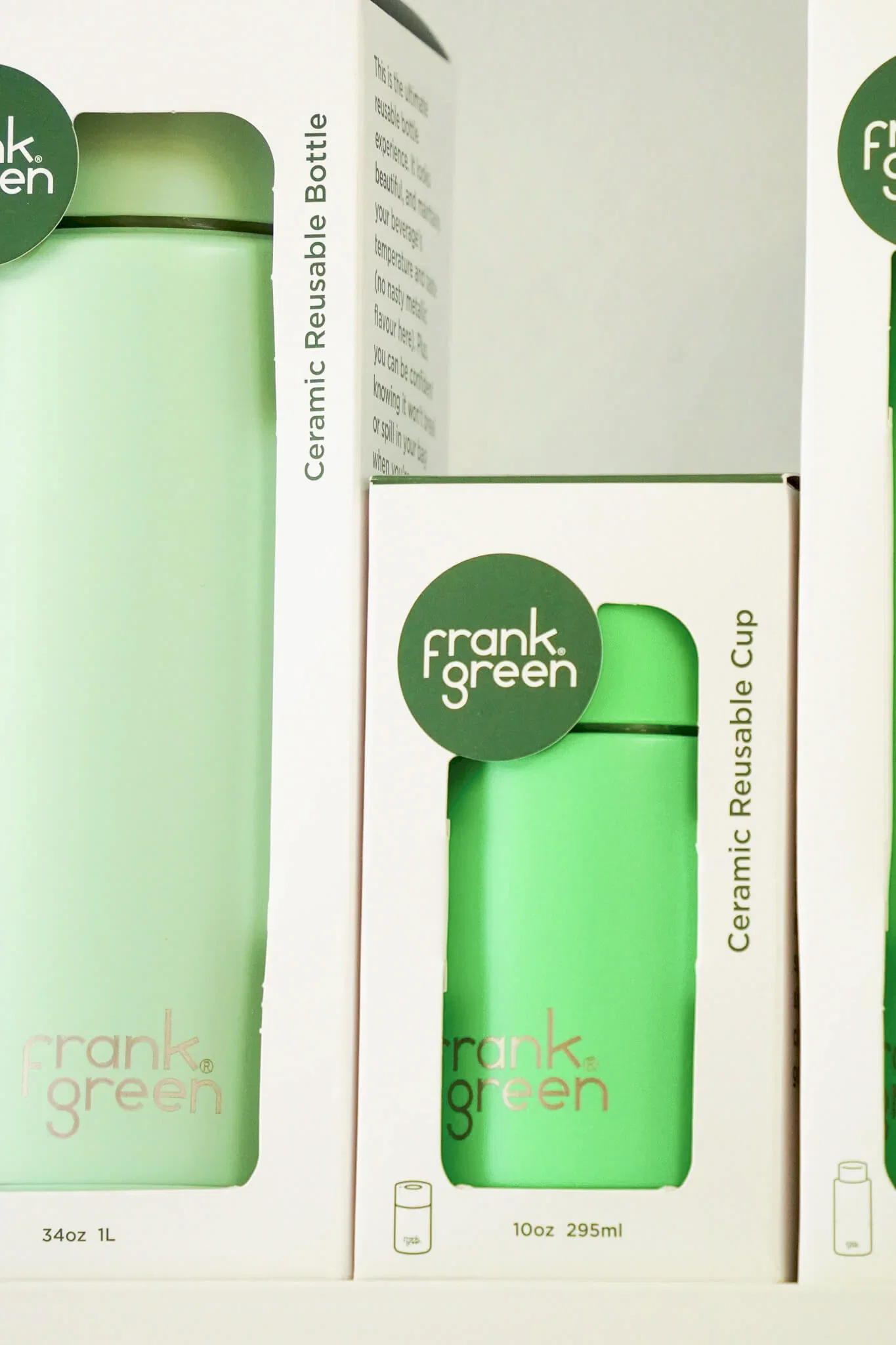 Frank Green ceramic reusable bottles and cups displayed in minimalist white packaging with green accents and branding.